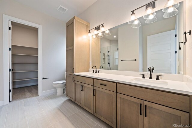 1724 Barefoot Dr, Windsor, CO 80550 - bathroom featuring double vanity, a shower stall, toilet, baseboards, and a spacious closet