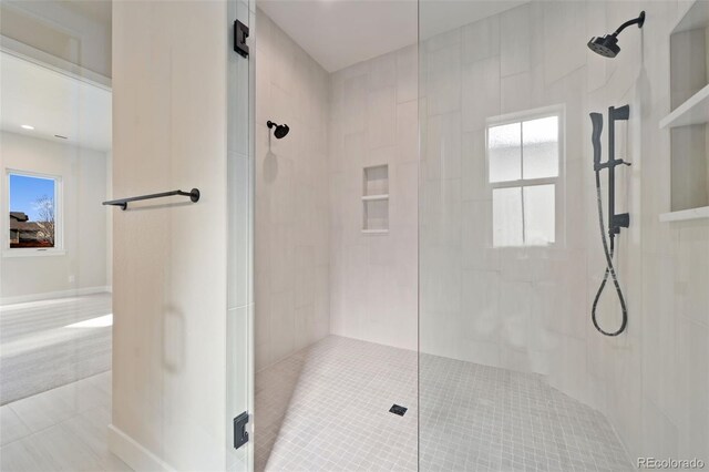 1724 Barefoot Dr, Windsor, CO 80550 - bathroom featuring tile patterned floors, a tile shower, and healthy amount of natural light