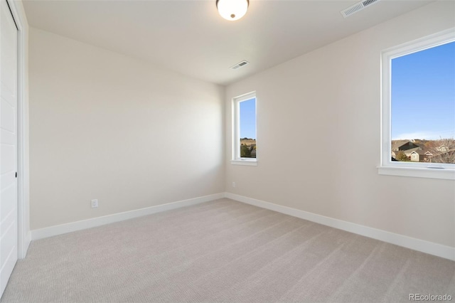 1724 Barefoot Dr, Windsor, CO 80550 - unfurnished room with light carpet, plenty of natural light, and baseboards