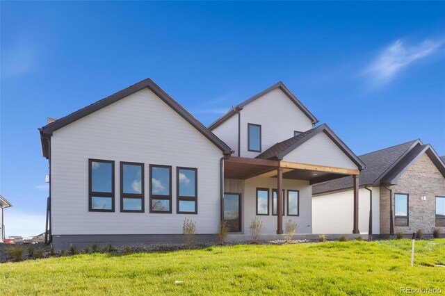 1724 Barefoot Dr, Windsor, CO 80550 - back of house featuring a yard