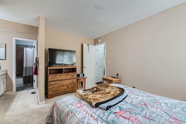 bedroom featuring light carpet and a textured ceiling