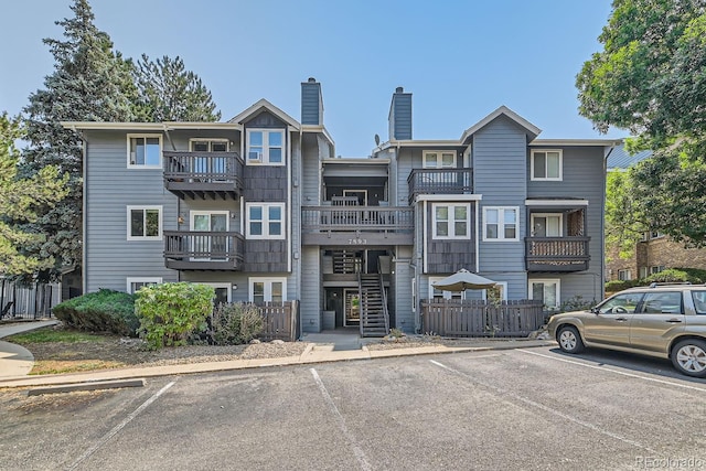 view of building exterior with uncovered parking