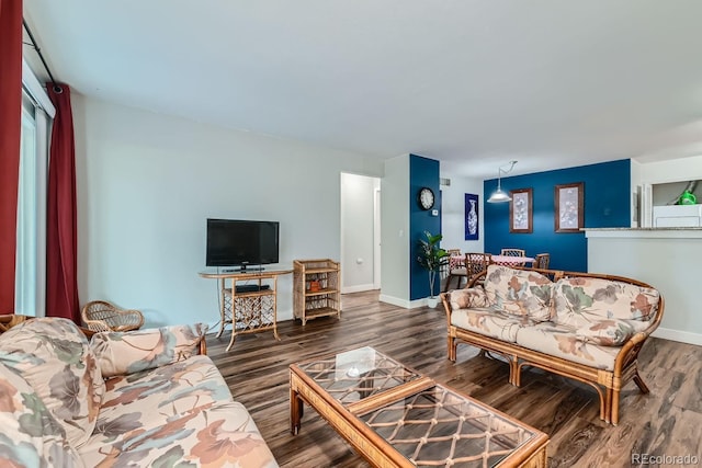 living area featuring baseboards and wood finished floors