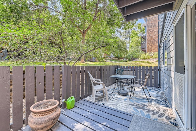 wooden terrace with outdoor dining space