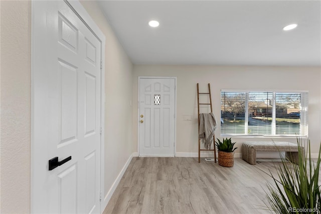 foyer featuring light wood-type flooring, baseboards, and recessed lighting