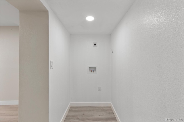 laundry room featuring light wood finished floors, laundry area, baseboards, hookup for an electric dryer, and washer hookup