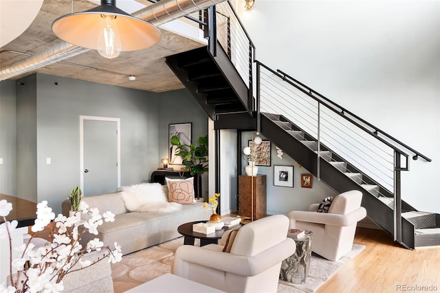 living room with wood finished floors and stairs