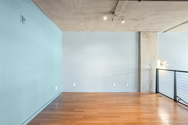 empty room with light wood-type flooring and visible vents