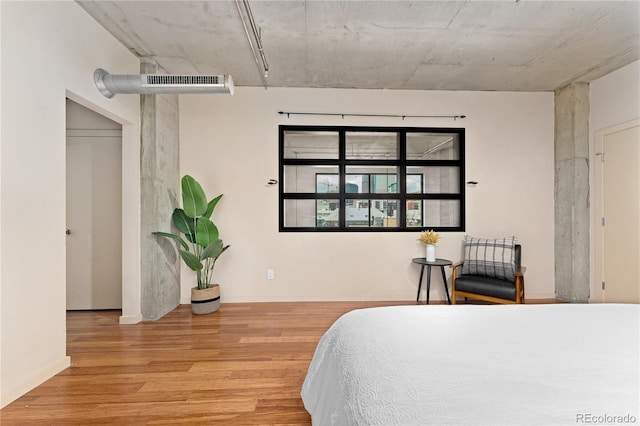 bedroom with wood finished floors and visible vents