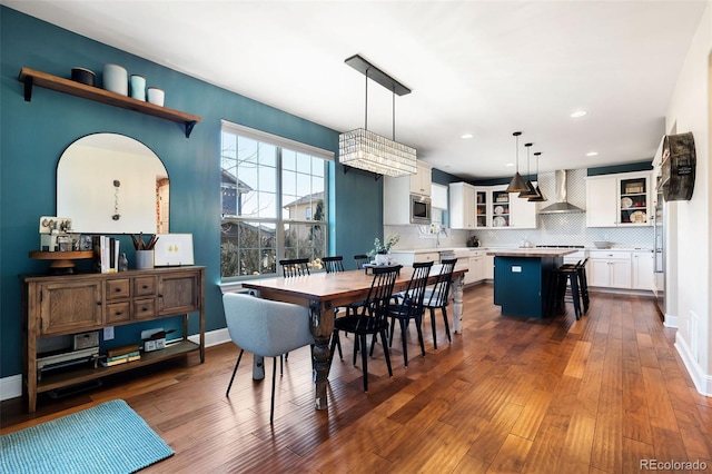 dining area with dark wood-style floors, baseboards, and recessed lighting