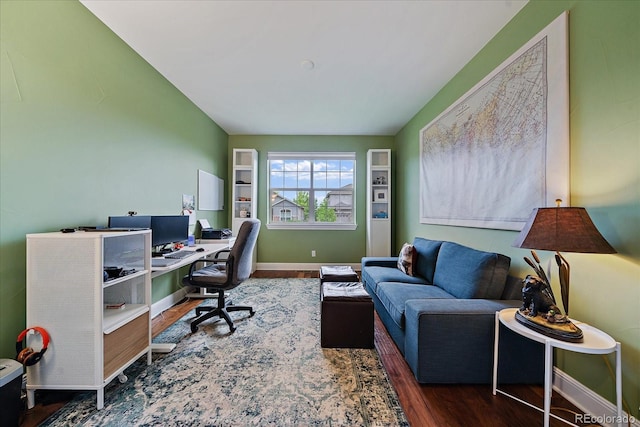 office space featuring baseboards and wood finished floors