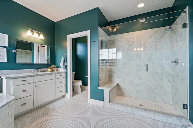 full bathroom featuring toilet, a shower stall, tile patterned flooring, and vanity