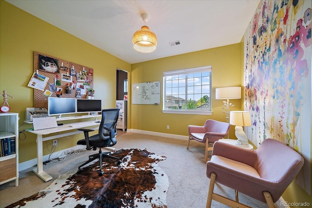 carpeted home office featuring visible vents and baseboards