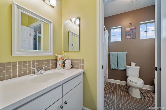 full bath with baseboards, visible vents, toilet, tile patterned floors, and vanity