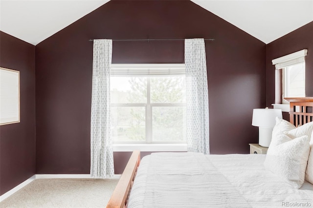 bedroom with baseboards, carpet flooring, and lofted ceiling