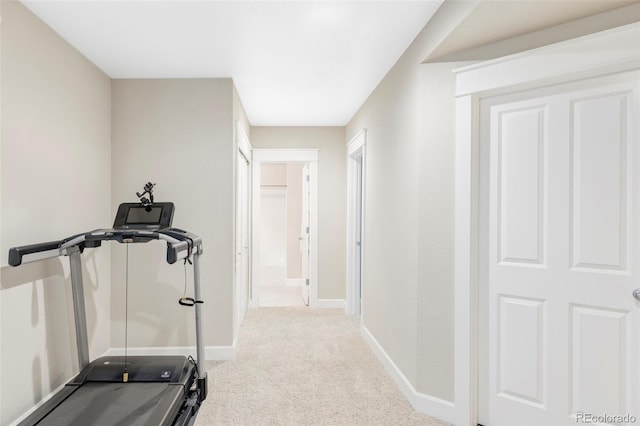 exercise area with baseboards and carpet