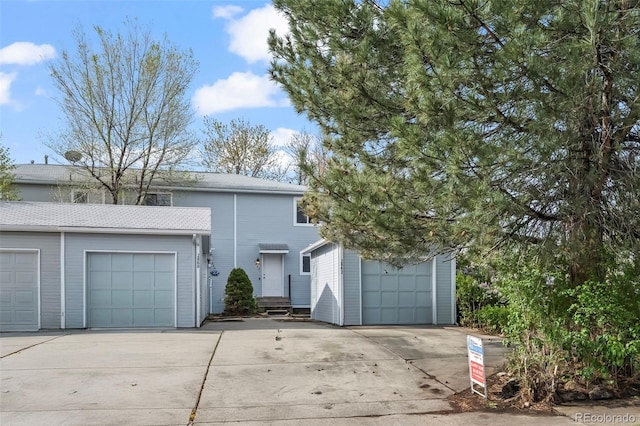 view of front of house with a garage and concrete driveway