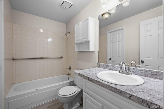 bathroom with toilet, shower / tub combination, wood finished floors, and vanity