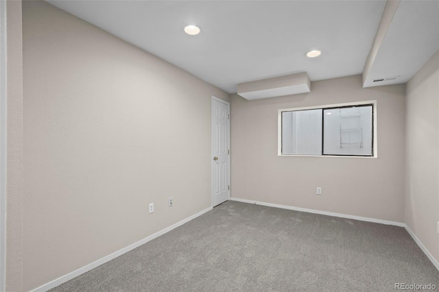 spare room featuring baseboards, carpet flooring, and recessed lighting