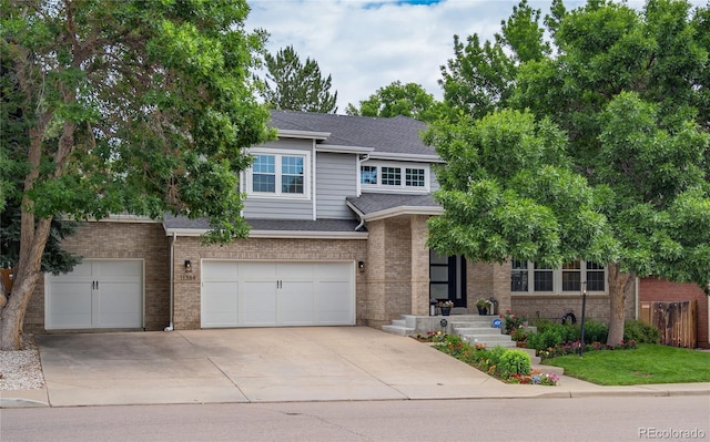 11389 E Maplewood Ave, Englewood, CO 80111 - view of front of property with driveway, a garage, a shingled roof, and brick siding