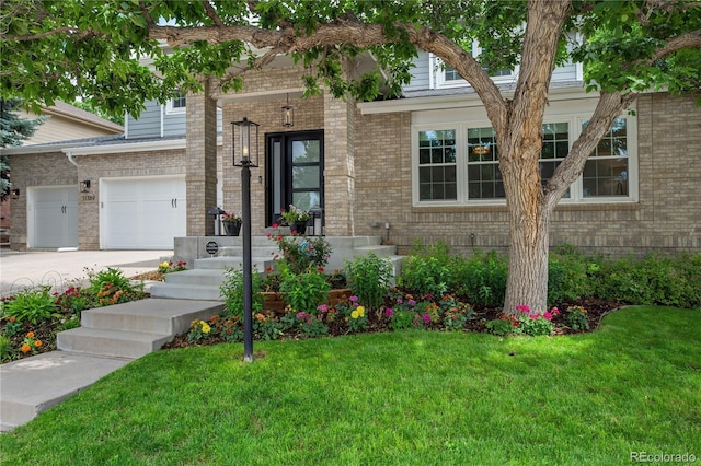 11389 E Maplewood Ave, Englewood, CO 80111 - view of front of house featuring brick siding, a front lawn, and concrete driveway