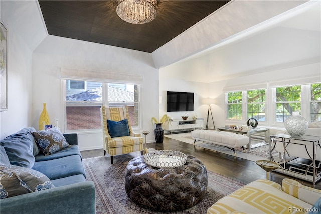 11389 E Maplewood Ave, Englewood, CO 80111 - living area with vaulted ceiling, healthy amount of natural light, wood finished floors, and a chandelier
