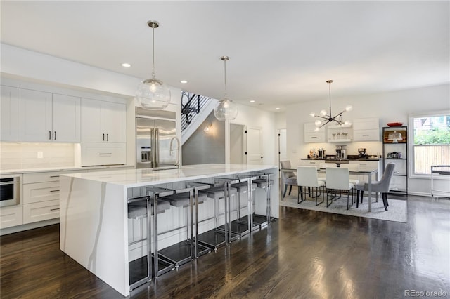 11389 E Maplewood Ave, Englewood, CO 80111 - kitchen featuring stainless steel appliances, dark wood-type flooring, a chandelier, and recessed lighting