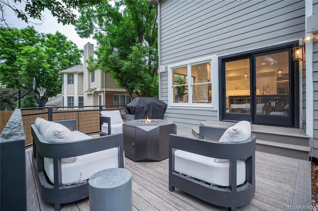11389 E Maplewood Ave, Englewood, CO 80111 - wooden terrace featuring area for grilling and an outdoor living space with a fire pit
