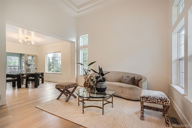 22367 Quail Run Dr, Parker, CO 80138 - living area featuring a high ceiling, wood finished floors, and a chandelier
