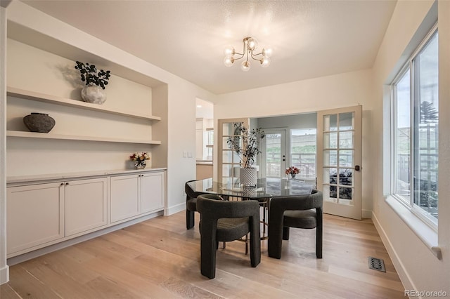 22367 Quail Run Dr, Parker, CO 80138 - dining space featuring a chandelier, plenty of natural light, and light wood-type flooring