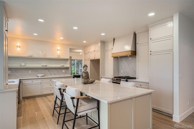 22367 Quail Run Dr, Parker, CO 80138 - kitchen with custom exhaust hood, open shelves, recessed lighting, decorative backsplash, and a kitchen island