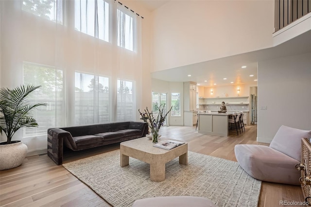 22367 Quail Run Dr, Parker, CO 80138 - living room featuring a towering ceiling and light wood finished floors