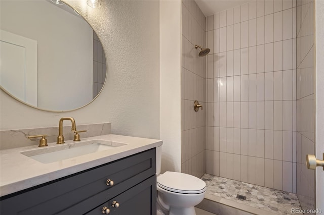 22367 Quail Run Dr, Parker, CO 80138 - full bathroom featuring vanity, a tile shower, and a textured wall