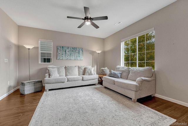 living room featuring dark hardwood / wood-style flooring and ceiling fan