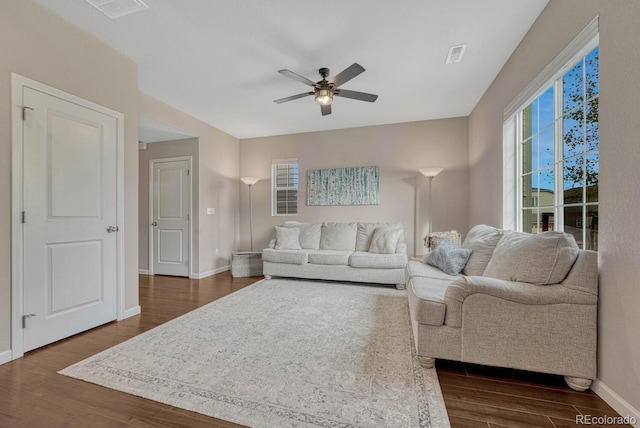 living room with ceiling fan and dark hardwood / wood-style floors