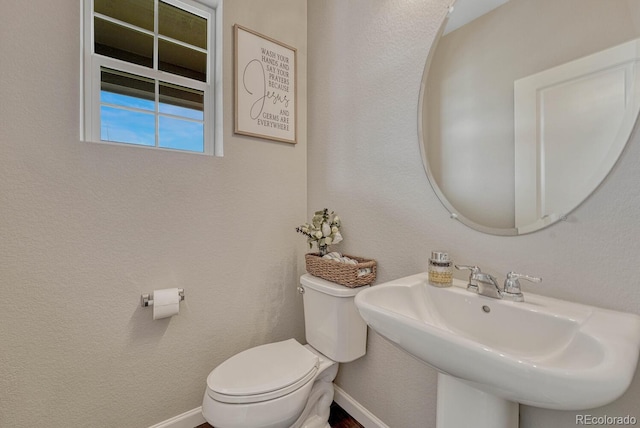 bathroom featuring toilet and sink