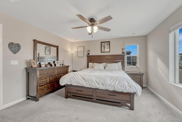 bedroom with light colored carpet and ceiling fan