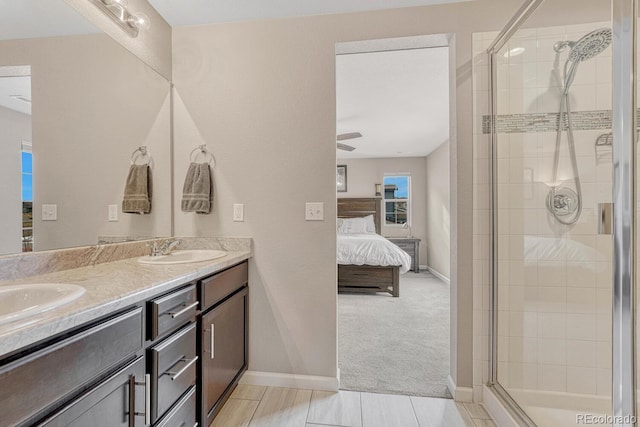 bathroom with ceiling fan, an enclosed shower, and vanity