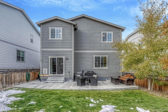 rear view of house with a yard and a patio area