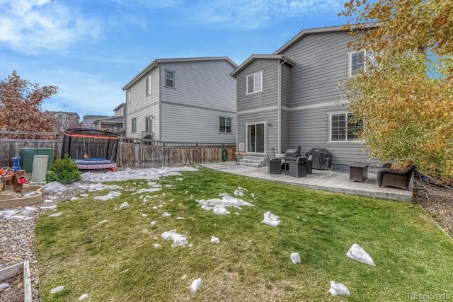 rear view of house featuring a yard, a patio, and a trampoline