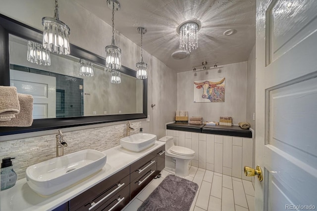 403 Scott St, Salida, CO 81201 - full bathroom featuring tasteful backsplash, a chandelier, double vanity, and toilet