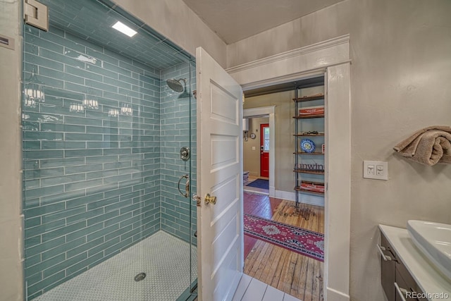 403 Scott St, Salida, CO 81201 - bathroom with a shower stall, vanity, baseboards, and wood finished floors
