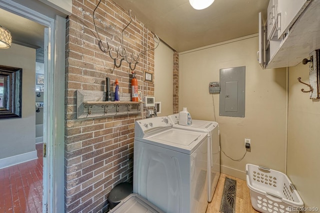 403 Scott St, Salida, CO 81201 - laundry room featuring electric panel, cabinet space, washer and clothes dryer, baseboards, and brick wall
