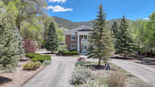 403 Scott St, Salida, CO 81201 - view of front facade with driveway, a mountain view, french doors, and brick siding