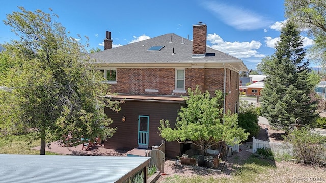 403 Scott St, Salida, CO 81201 - back of house with a chimney, a patio, roof with shingles, and brick siding