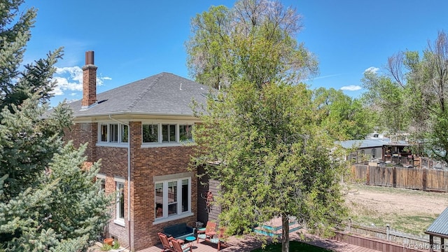 403 Scott St, Salida, CO 81201 - rear view of property with brick siding, a chimney, and roof with shingles