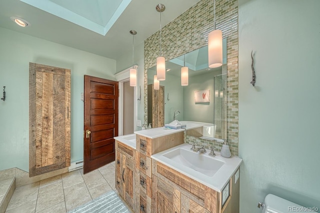 403 Scott St, Salida, CO 81201 - bathroom featuring vanity, toilet, a bathtub, a baseboard radiator, and tile patterned floors