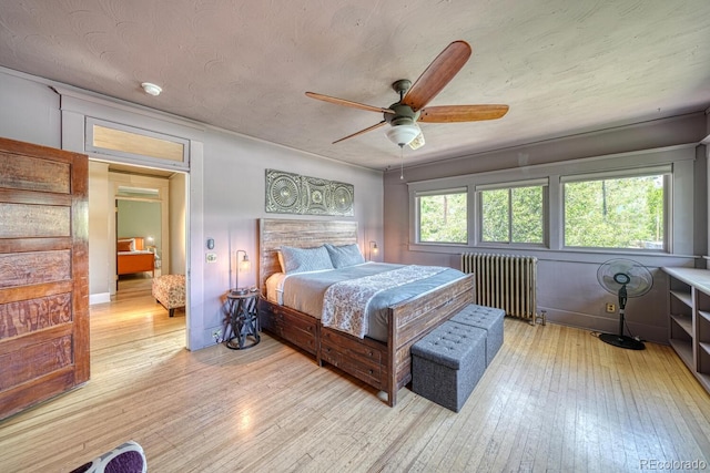 403 Scott St, Salida, CO 81201 - bedroom with radiator heating unit, light wood-style floors, and ceiling fan