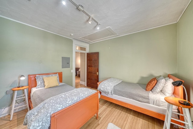 403 Scott St, Salida, CO 81201 - bedroom with attic access, track lighting, wood finished floors, electric panel, and ornamental molding