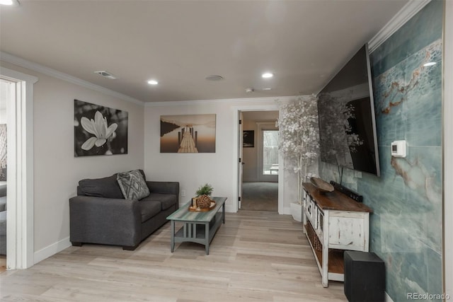 living room featuring crown molding and light hardwood / wood-style floors